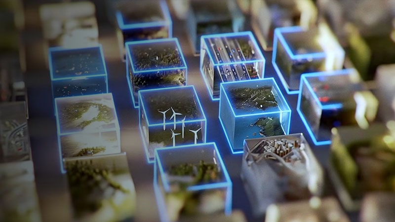 Grid of glowing digital cubes containing miniature scenes of wind turbines, cities, and nature.