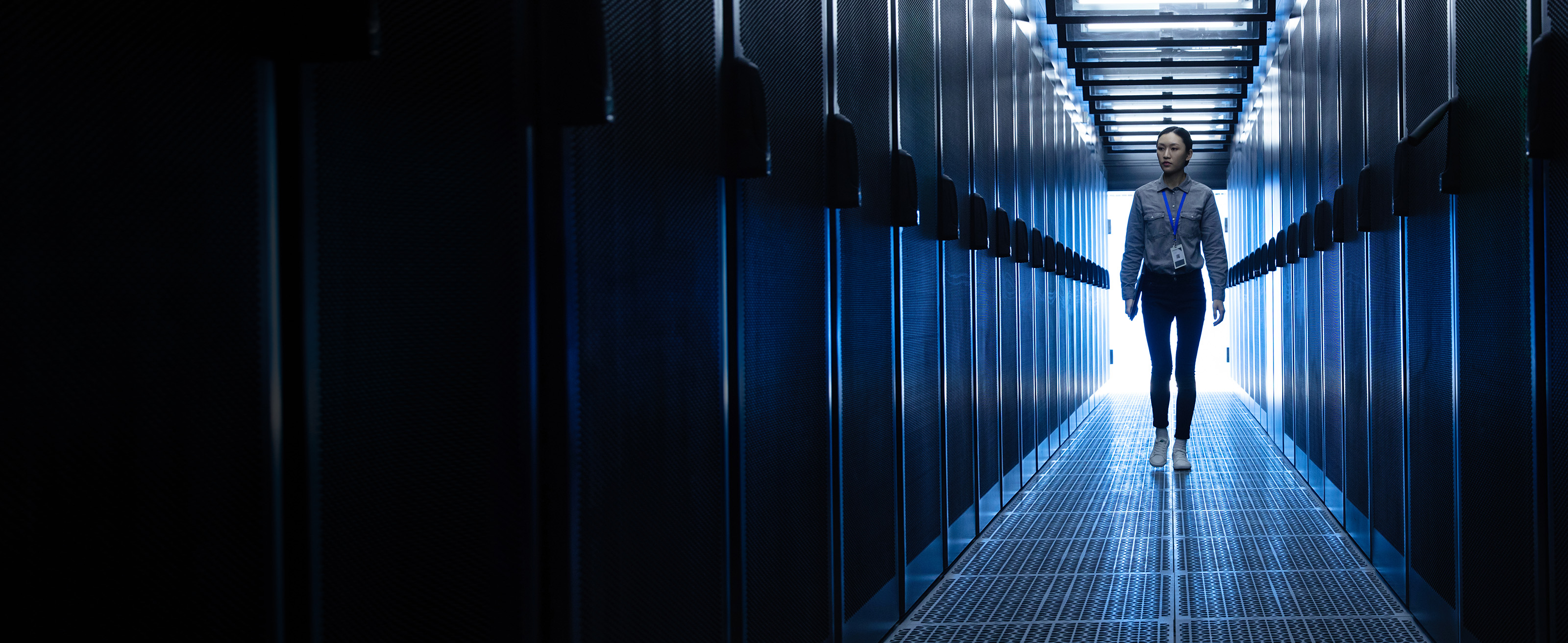 IT worker walking through enterprise server room