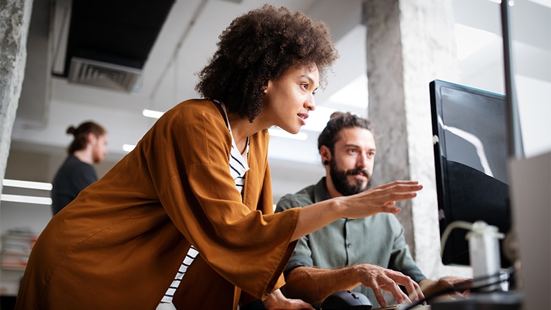 Programmers working cooperating at IT company developing apps