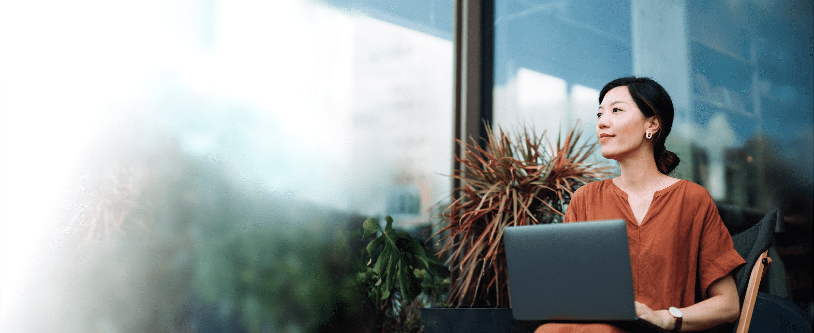 Woman using laptop in hybrid environment